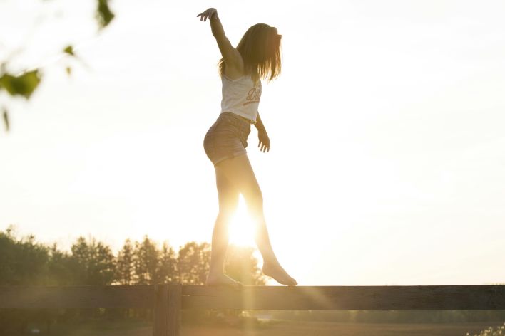 Woman Walking On Fence